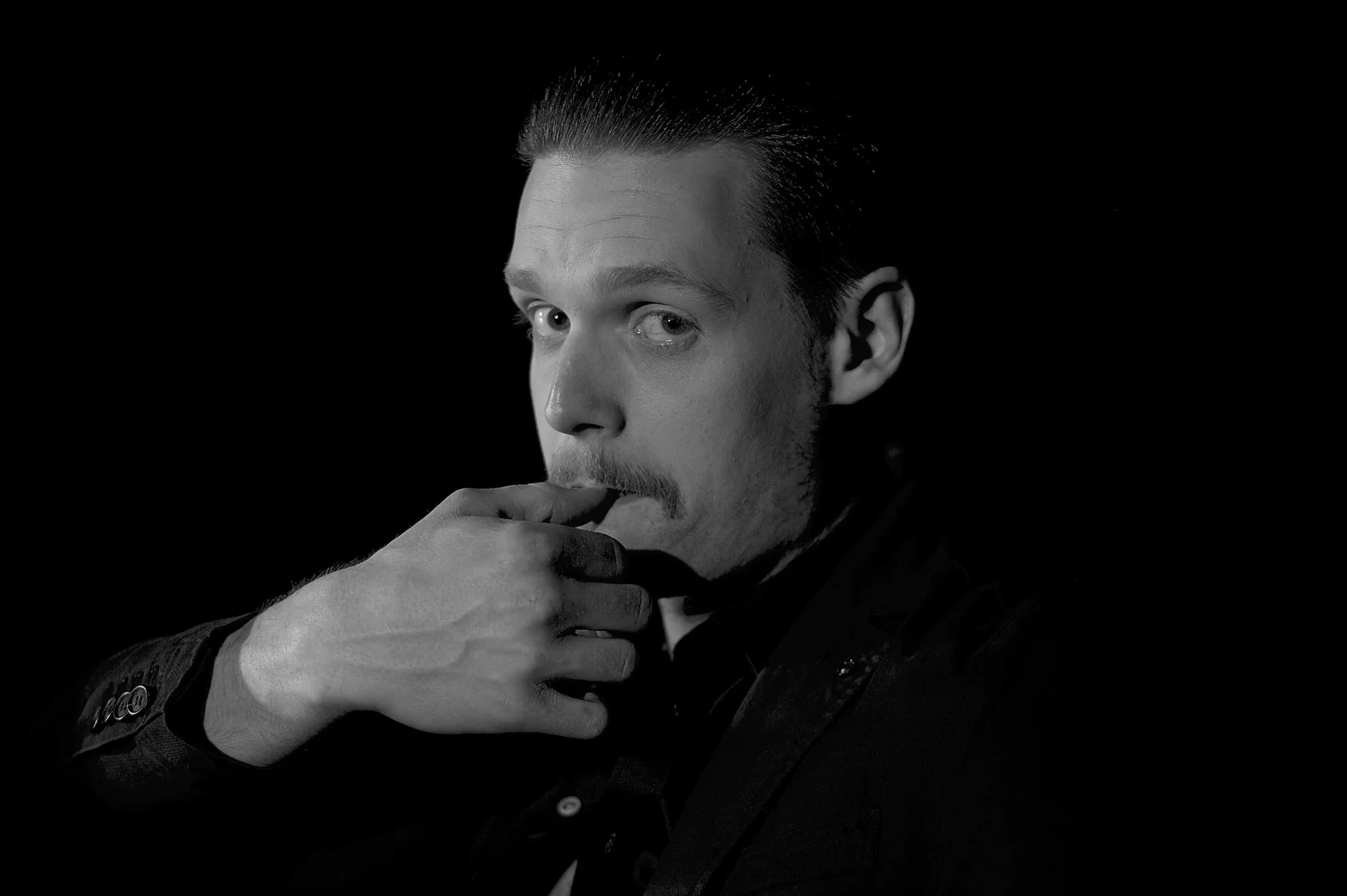 Dark studio portrait of Marcus Brody