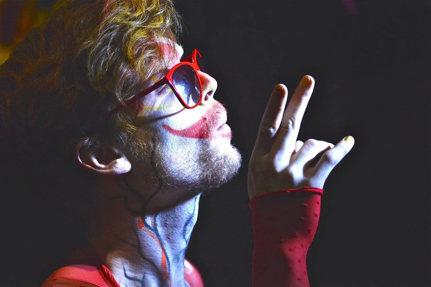 Marcus Brody performing under theatrical red and blue light