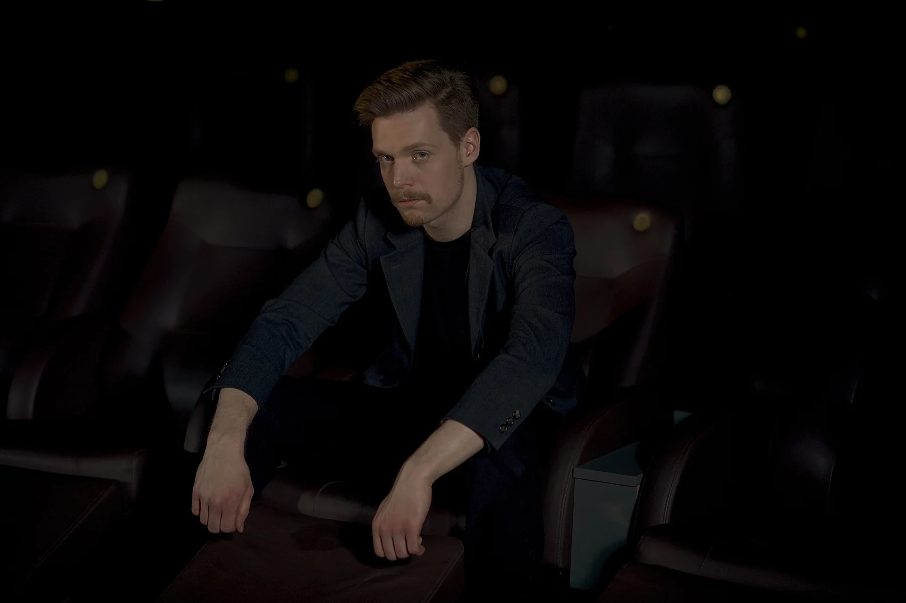 Marcus Brody seated during a stage performance