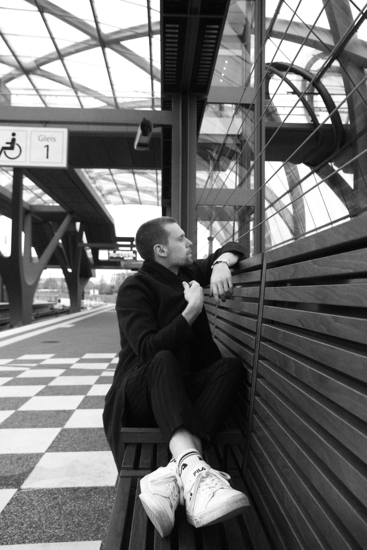 Black-and-white portrait of Marcus Brody at a station