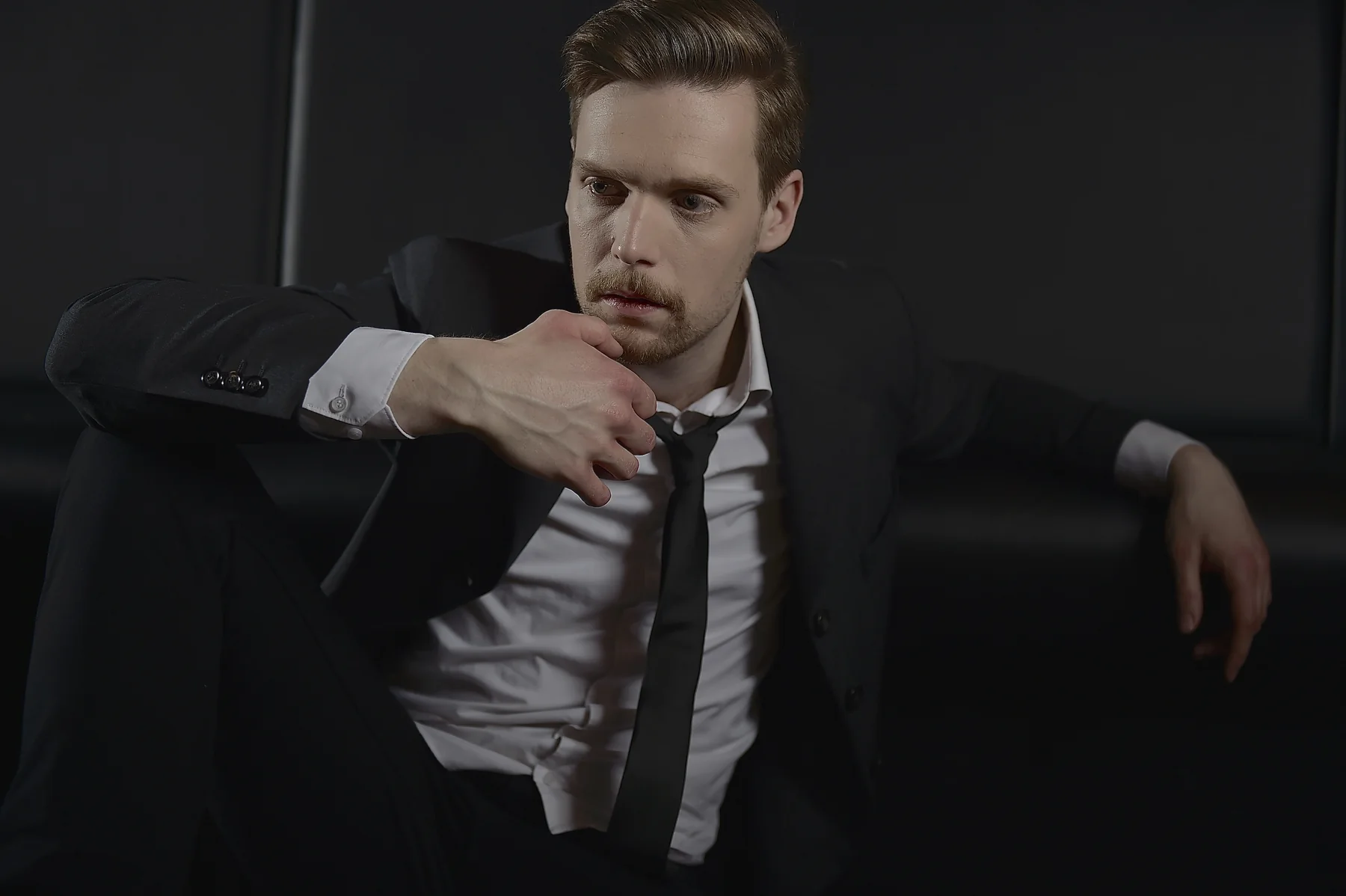 Marcus Brody in a suit during a performance